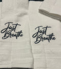 White hand towel with Just Breathe
