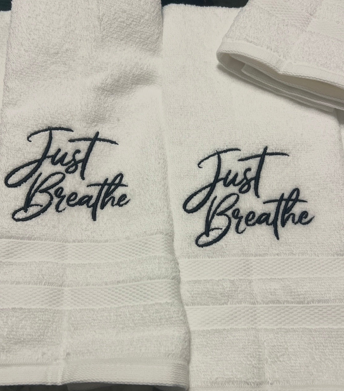 White hand towel with Just Breathe