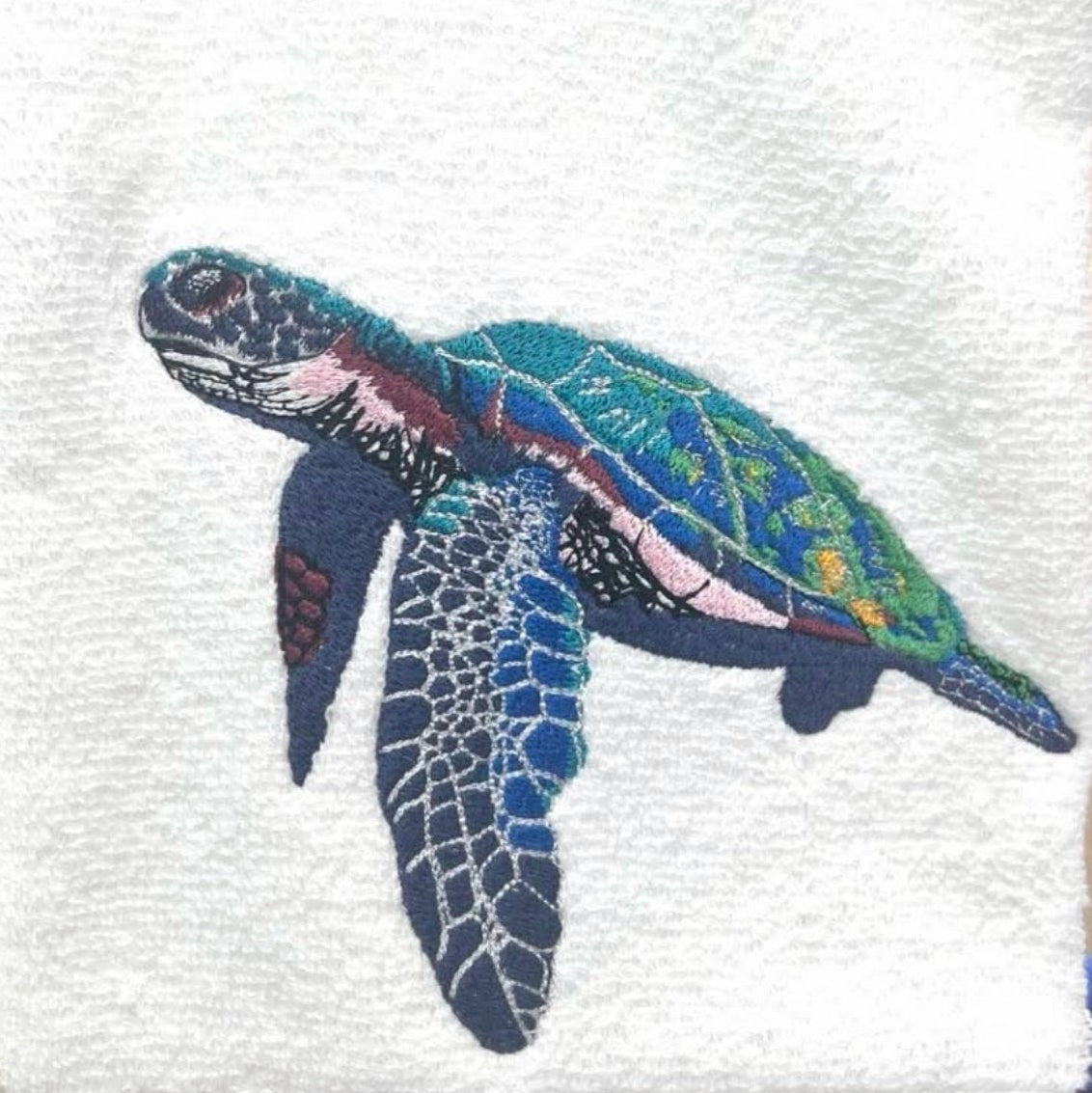 White hand towel with sea turtle