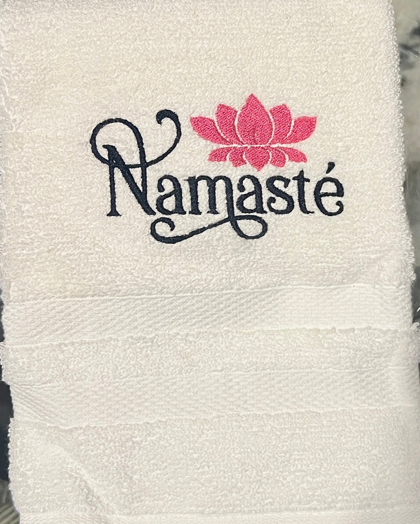 White hand towel with Namaste and lotus
