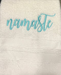 White hand towel with namaste