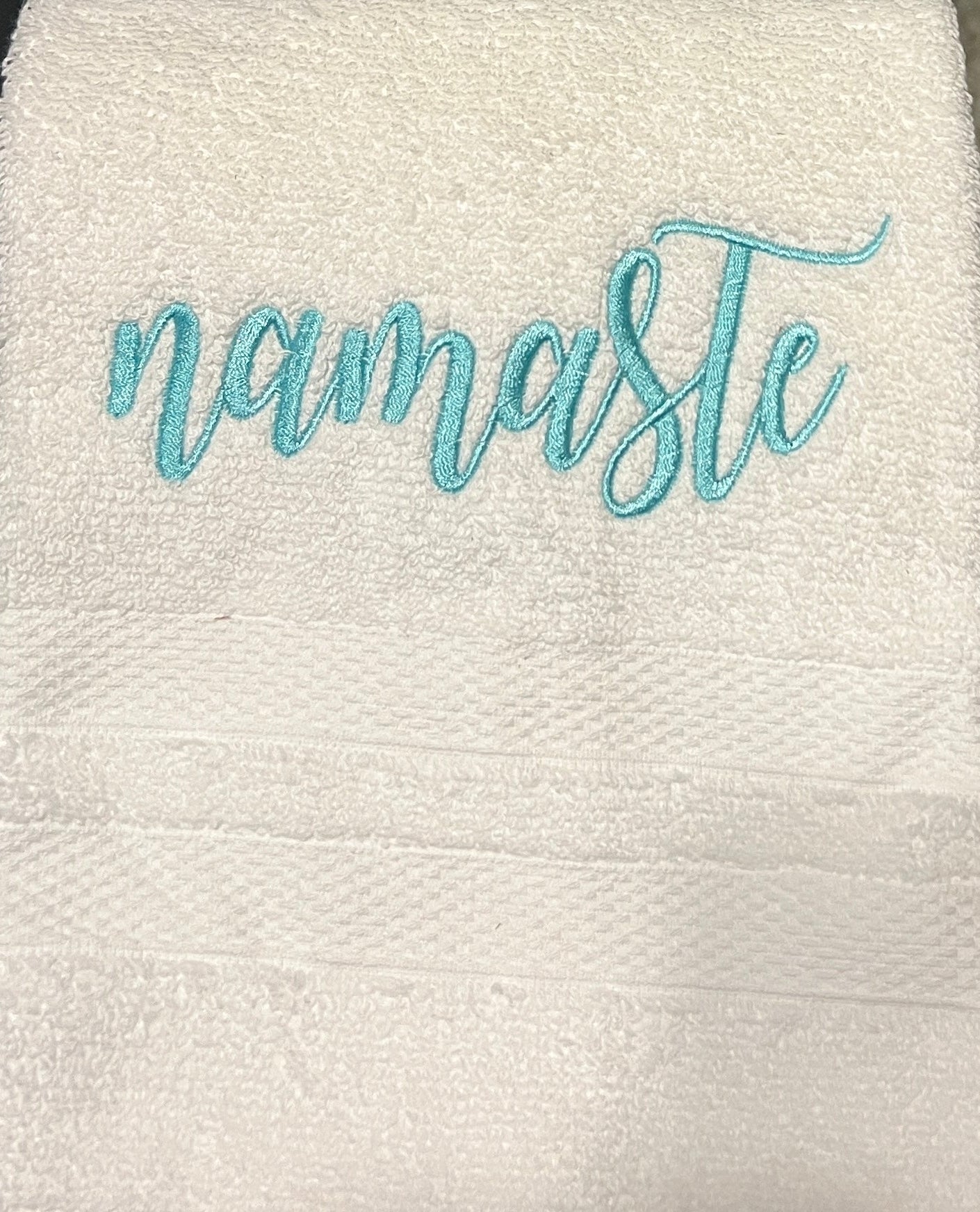 White hand towel with namaste